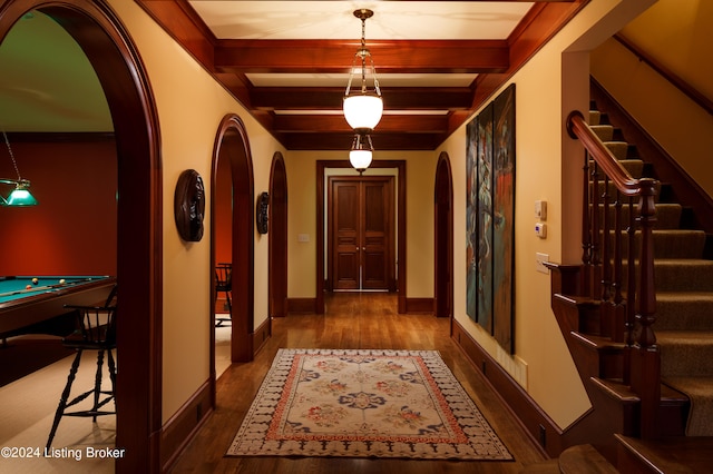 corridor featuring beamed ceiling and dark wood-type flooring