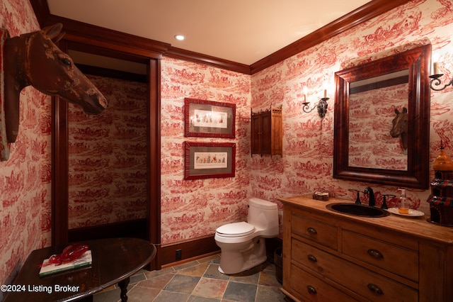 bathroom featuring toilet, crown molding, and vanity