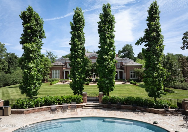 view of swimming pool with a patio and a lawn