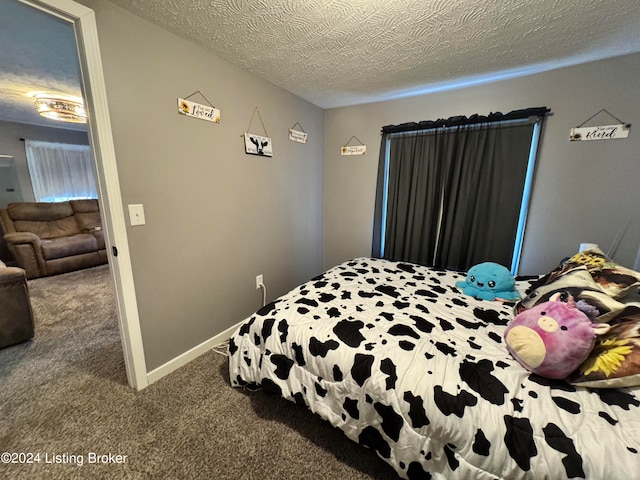 carpeted bedroom featuring a textured ceiling