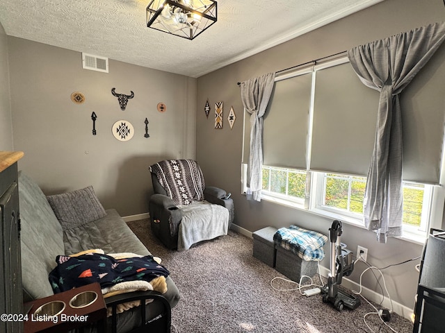 bedroom featuring a textured ceiling and carpet floors