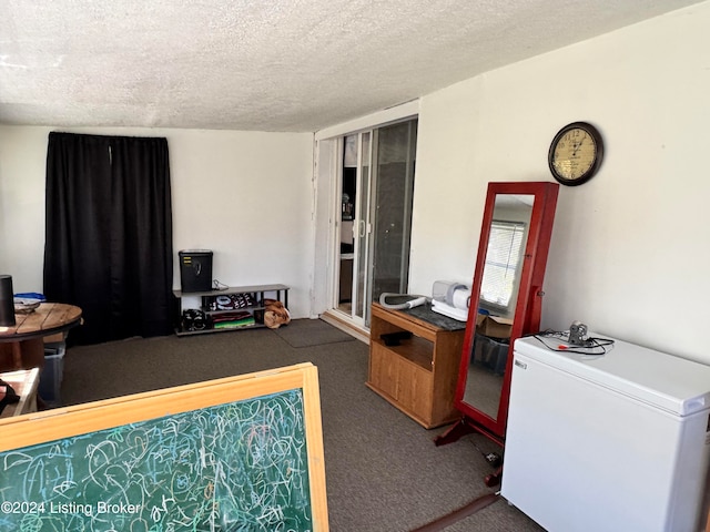 interior space with fridge and a textured ceiling