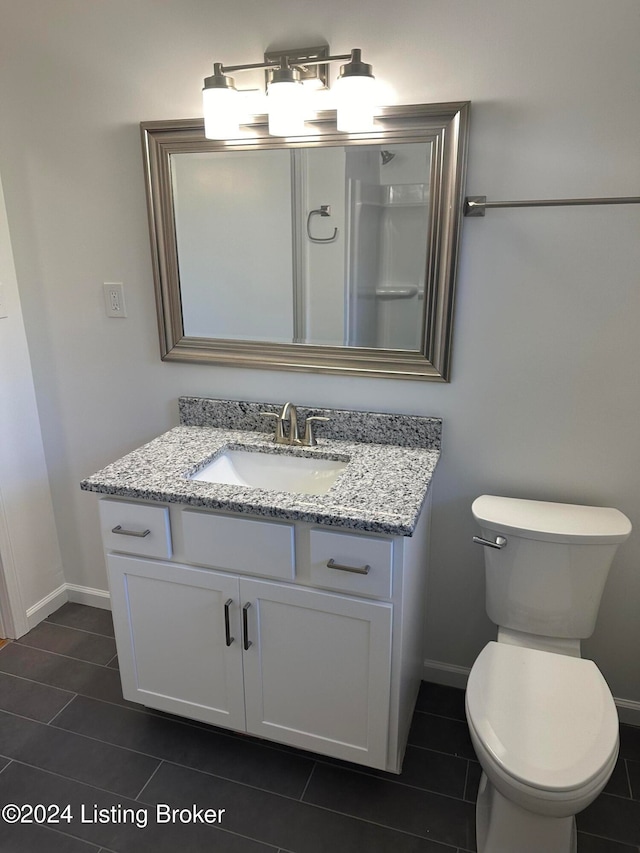 bathroom featuring vanity, toilet, and tile patterned floors