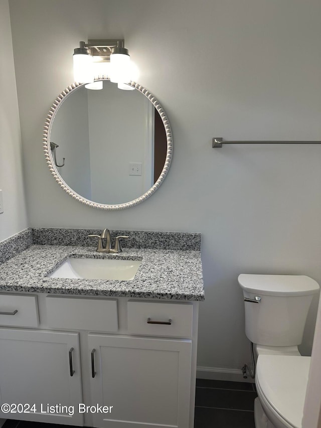 bathroom featuring vanity, toilet, and tile patterned floors