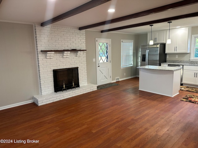 kitchen featuring white cabinets, ornamental molding, dark wood-type flooring, decorative light fixtures, and stainless steel appliances