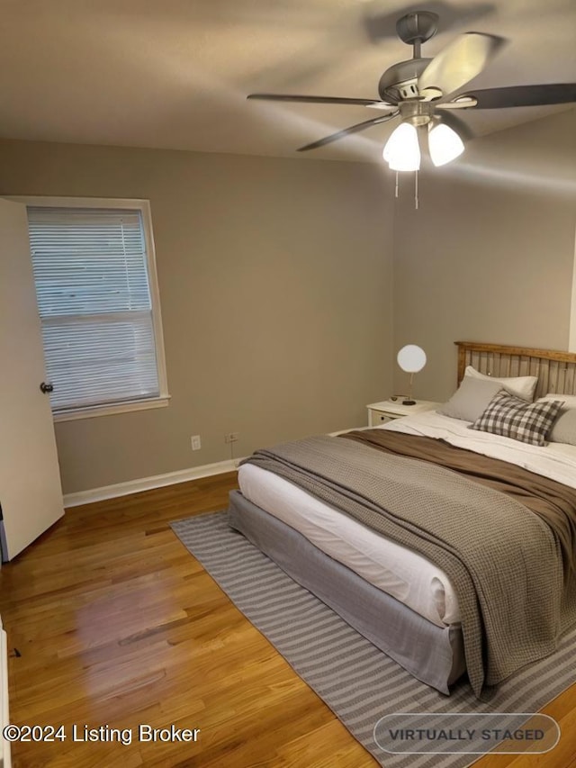 bedroom with ceiling fan and wood-type flooring