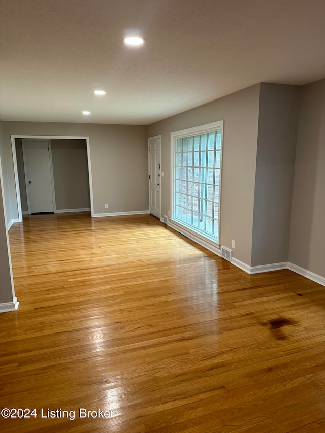 unfurnished room with light wood-type flooring