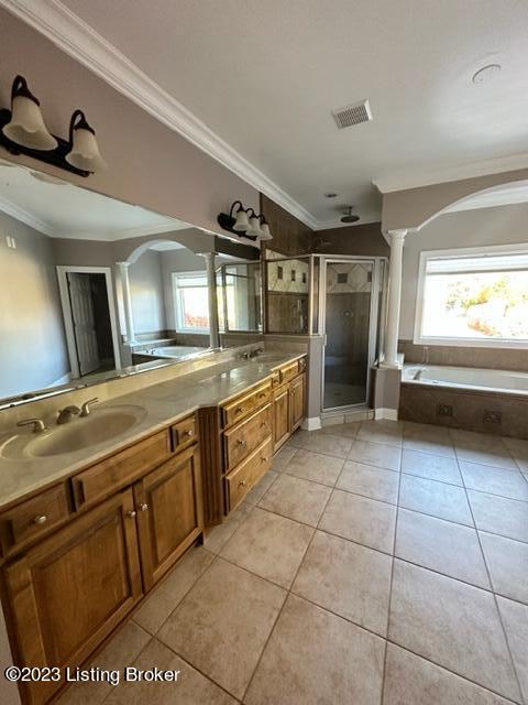 bathroom with vanity, ornamental molding, plus walk in shower, and tile patterned floors