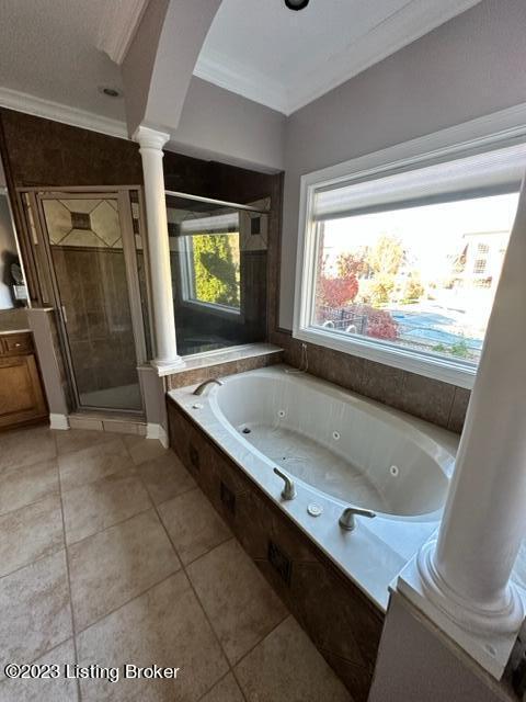 bathroom with tile patterned flooring, ornamental molding, and shower with separate bathtub