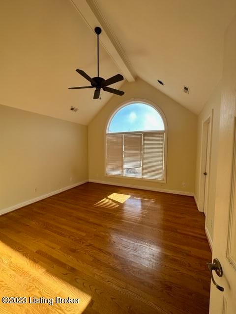 unfurnished room with lofted ceiling with beams, dark hardwood / wood-style floors, and ceiling fan