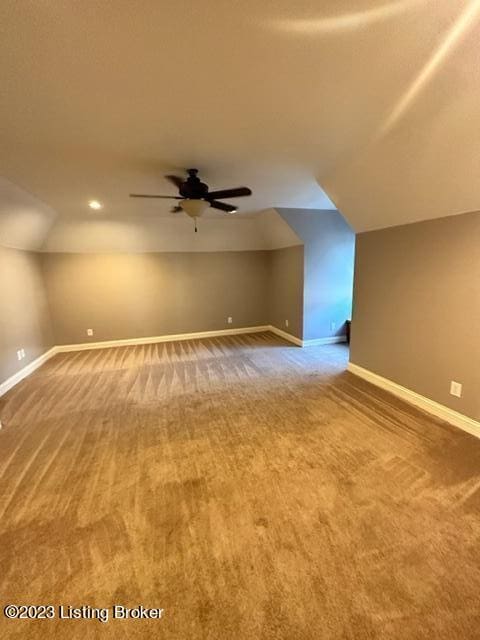 bonus room featuring lofted ceiling, carpet flooring, and ceiling fan