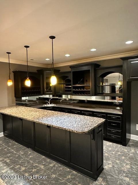 bar with ornamental molding, light stone countertops, and hanging light fixtures