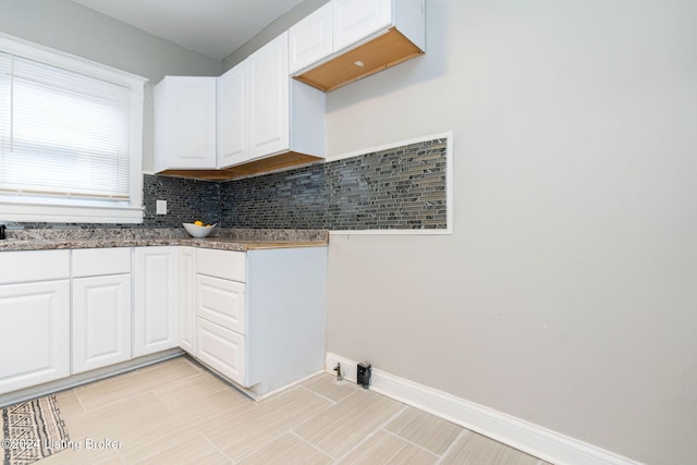 kitchen featuring white cabinetry and tasteful backsplash