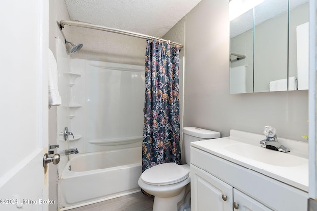 full bathroom featuring vanity, toilet, a textured ceiling, and shower / tub combo