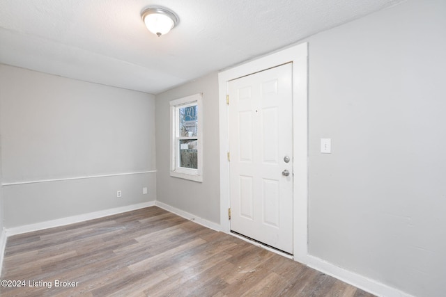 entrance foyer featuring light hardwood / wood-style floors and a textured ceiling