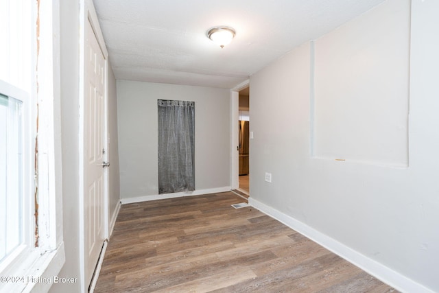 spare room with wood-type flooring