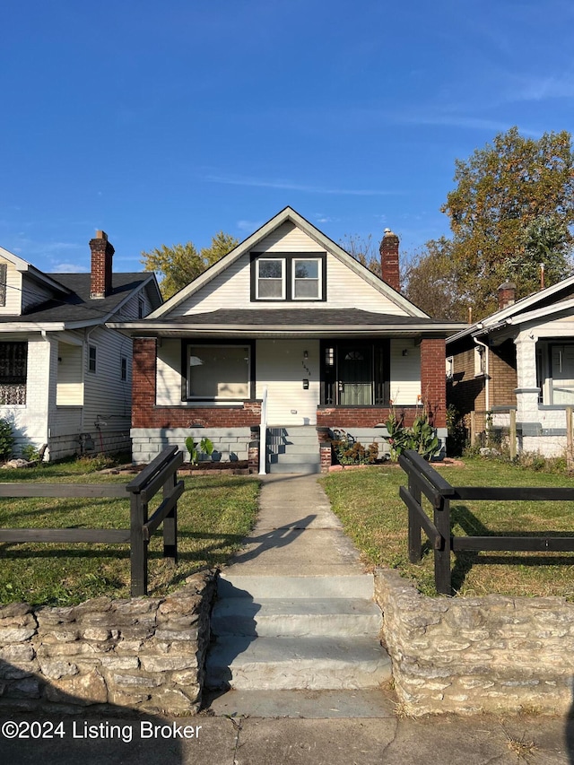 view of front of home with a front lawn and covered porch