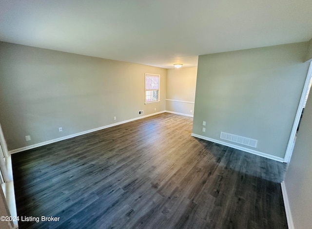 spare room featuring dark hardwood / wood-style flooring