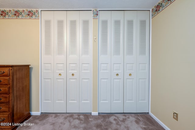 interior space with a textured ceiling and carpet floors