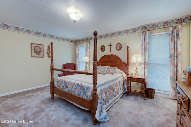 carpeted bedroom featuring a textured ceiling