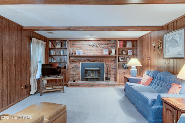 carpeted living room featuring beam ceiling, built in shelves, a wood stove, and wood walls