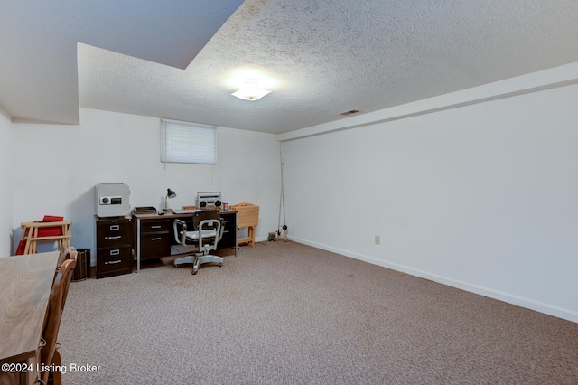 home office with a textured ceiling and carpet flooring