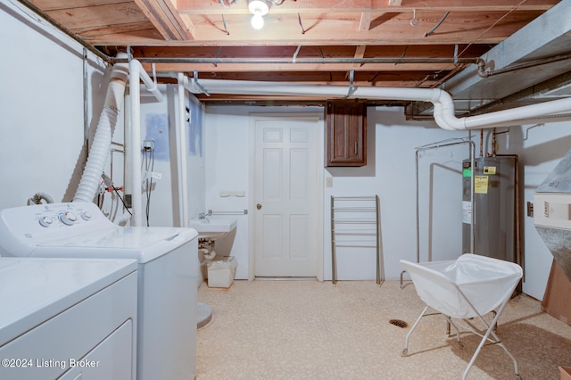 washroom with light carpet, electric water heater, and washing machine and dryer