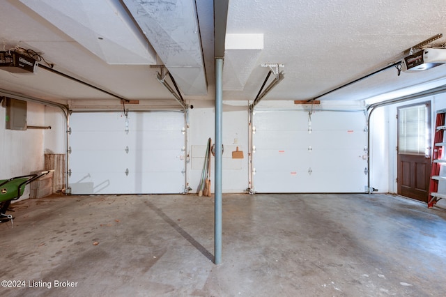 garage featuring a garage door opener and electric panel