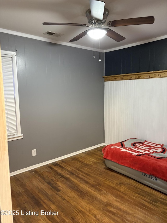 unfurnished bedroom featuring hardwood / wood-style floors, ceiling fan, and ornamental molding