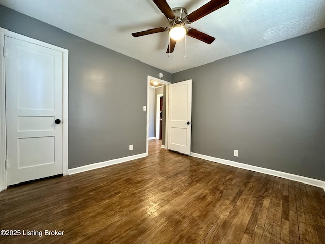 unfurnished bedroom with dark wood-type flooring and ceiling fan