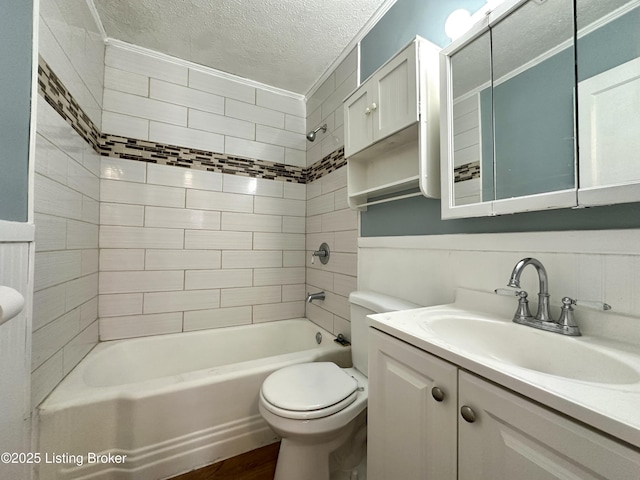 full bathroom with toilet, a textured ceiling, vanity, tiled shower / bath combo, and hardwood / wood-style flooring