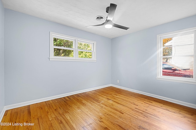 spare room with ceiling fan, light hardwood / wood-style floors, and a wealth of natural light