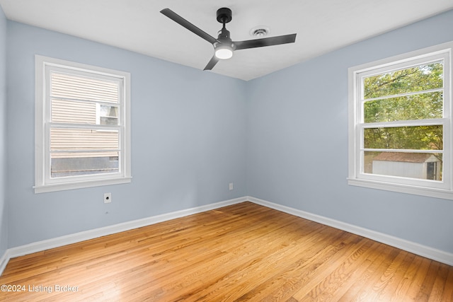 unfurnished room with light wood-type flooring and ceiling fan