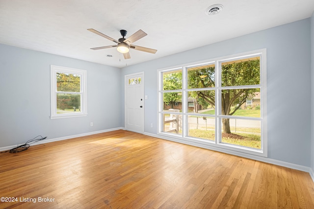 empty room featuring ceiling fan and light hardwood / wood-style floors