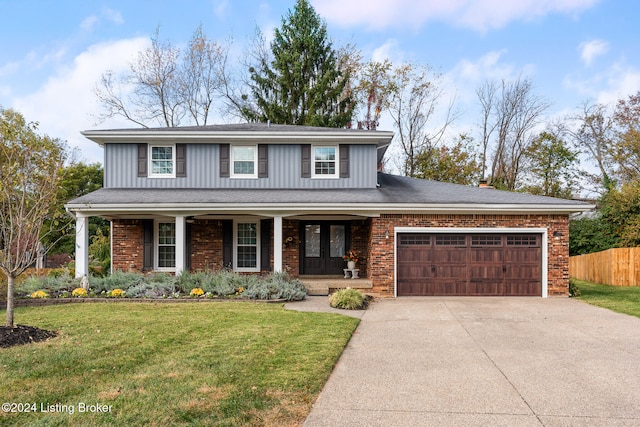 view of front property with a front yard, a garage, and a porch