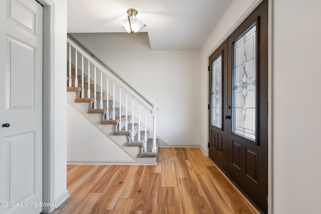 entrance foyer with hardwood / wood-style flooring and a healthy amount of sunlight