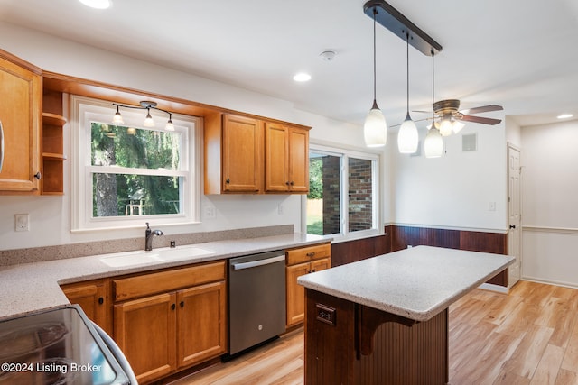 kitchen with a wealth of natural light, dishwasher, pendant lighting, and light wood-type flooring