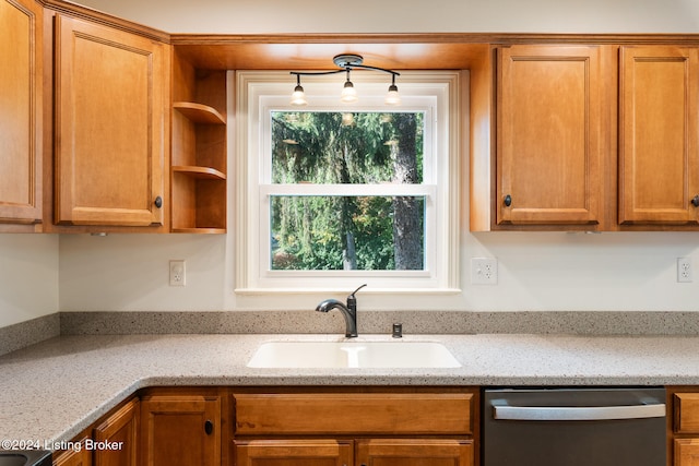 kitchen with sink, light stone counters, and dishwasher