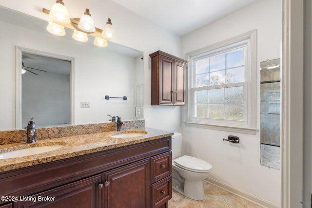 bathroom with ceiling fan, a shower with door, toilet, vanity, and tile patterned flooring