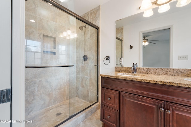 bathroom with vanity, ceiling fan, and walk in shower