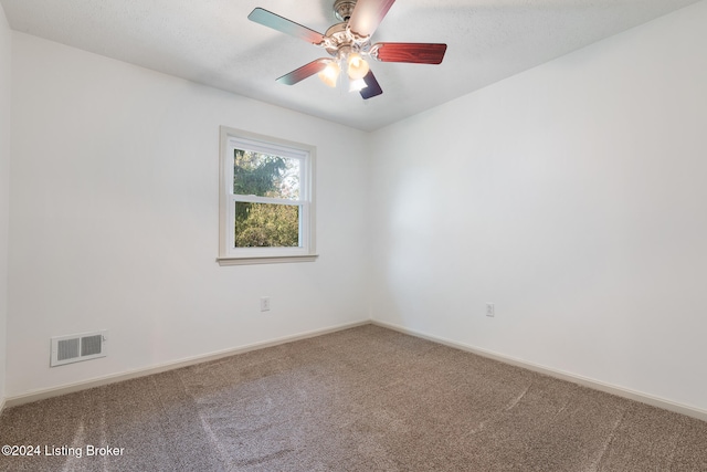 carpeted empty room featuring ceiling fan