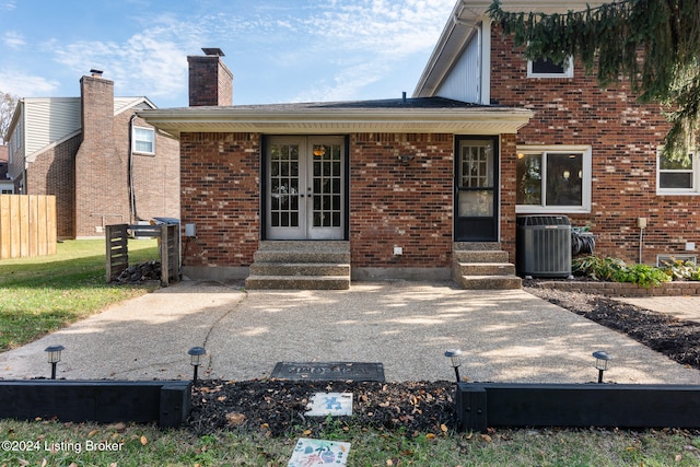 back of property featuring central AC