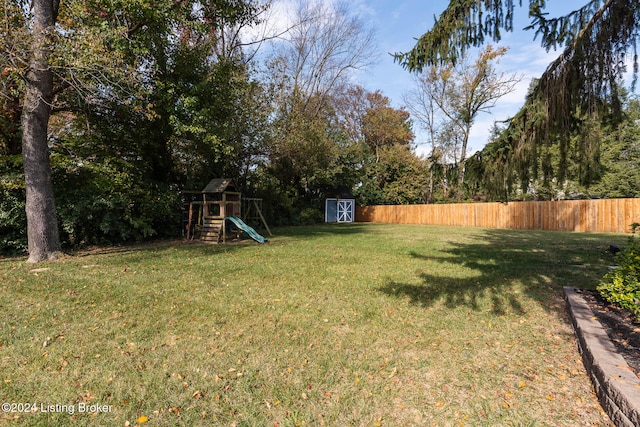 view of yard with a storage unit and a playground