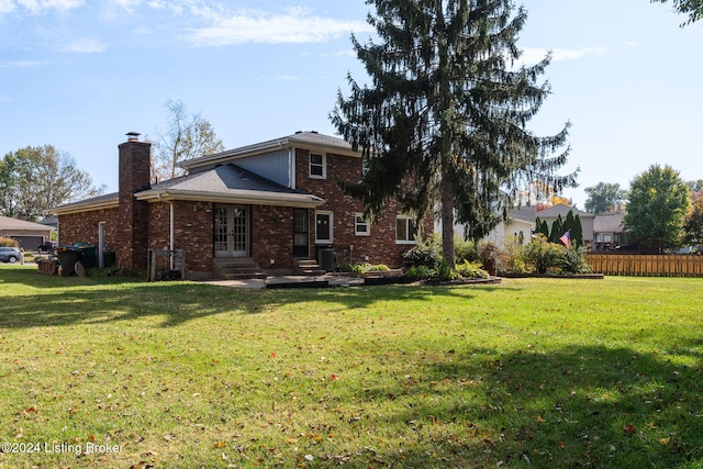 back of house with a lawn