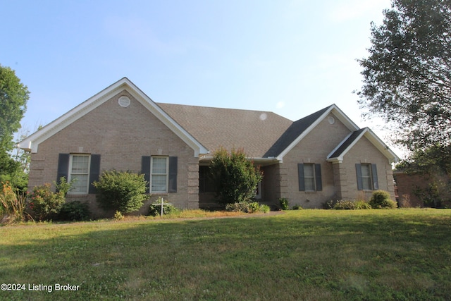 single story home featuring a front yard