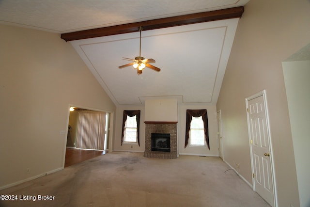 unfurnished living room featuring light carpet, a healthy amount of sunlight, and beamed ceiling