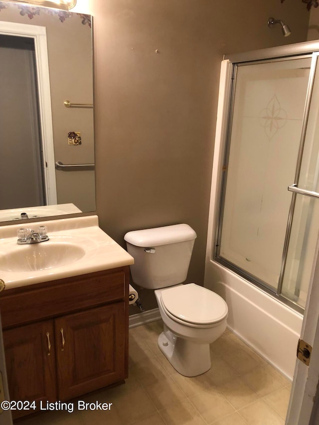 full bathroom featuring vanity, toilet, and shower / bath combination with glass door