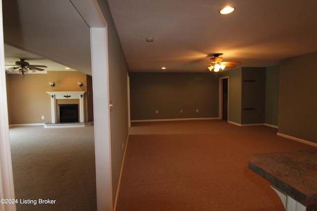 carpeted empty room featuring ceiling fan