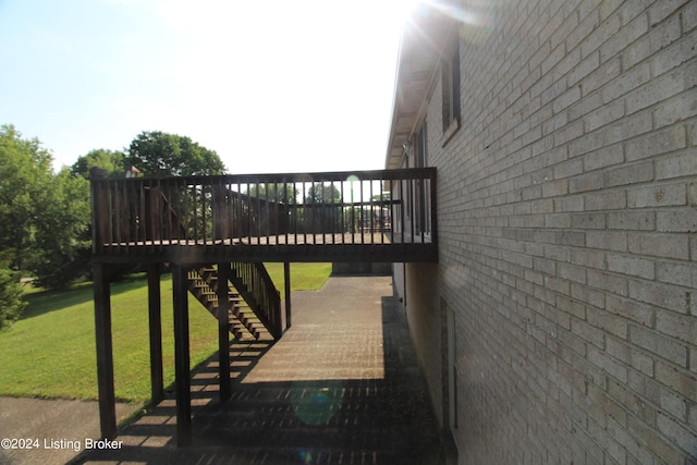 wooden deck featuring a yard