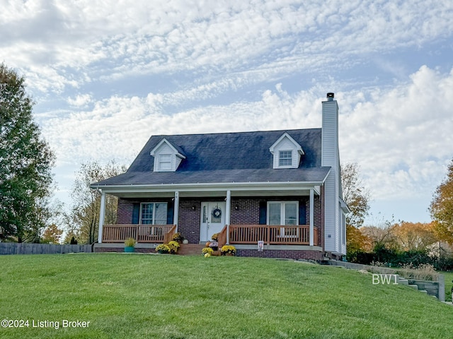 new england style home with a porch and a front lawn